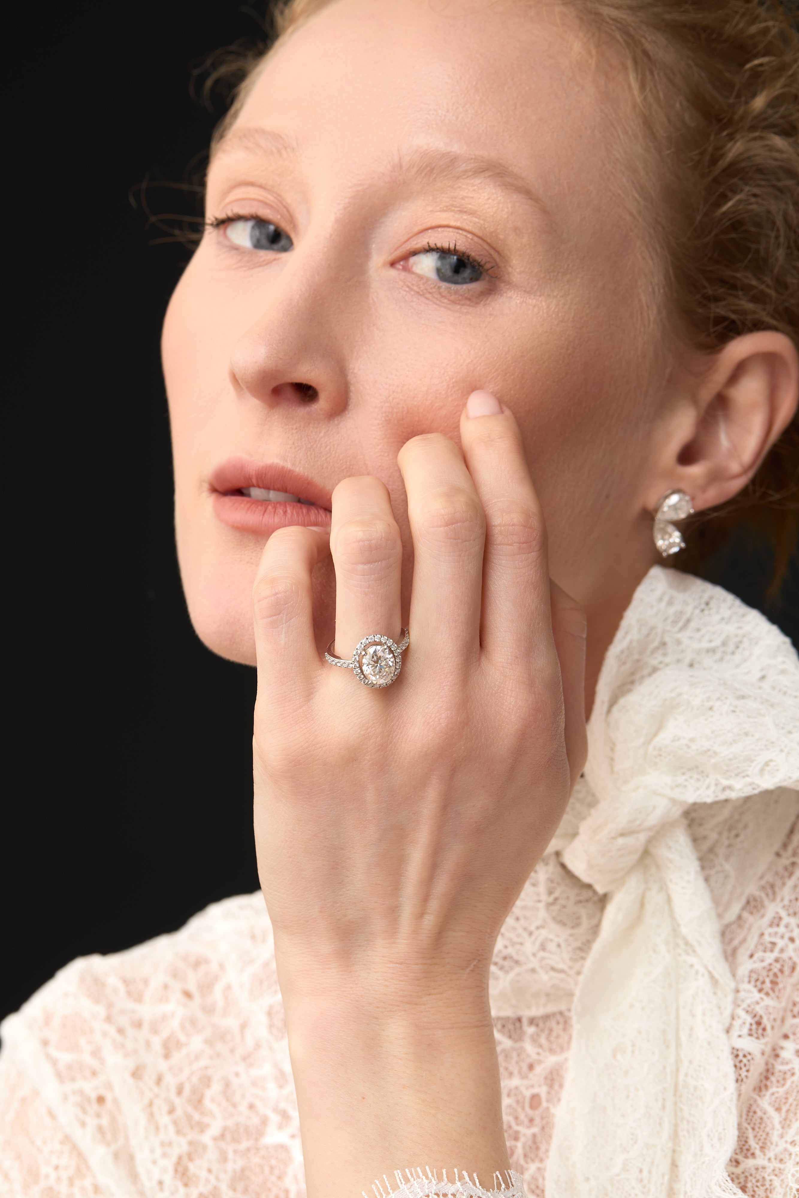 Luxury oval diamond engagement ring UK on hand, platinum halo setting, high-end bespoke diamond ring London