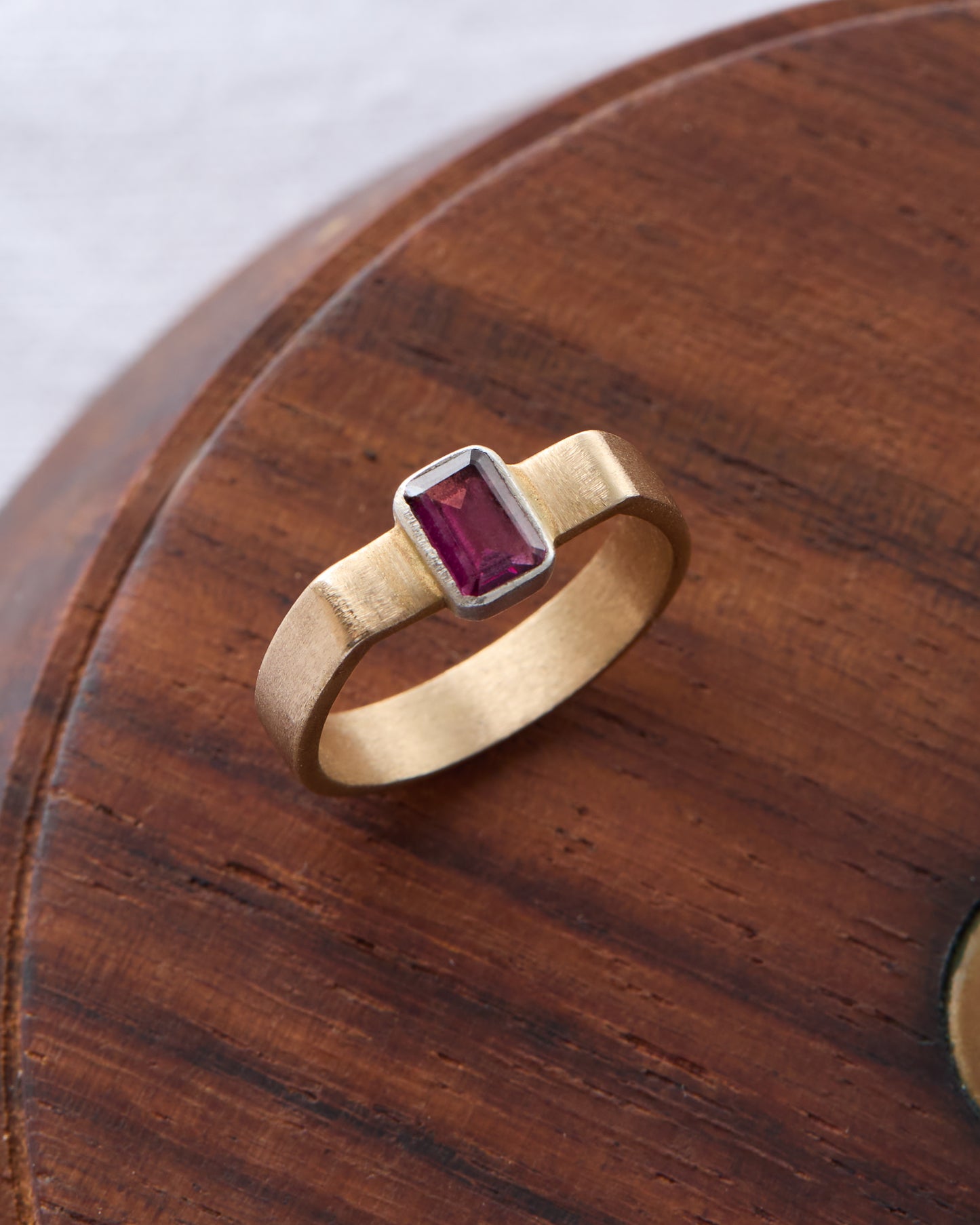Detailed view of the ring's open cuff structure and gemstone setting.