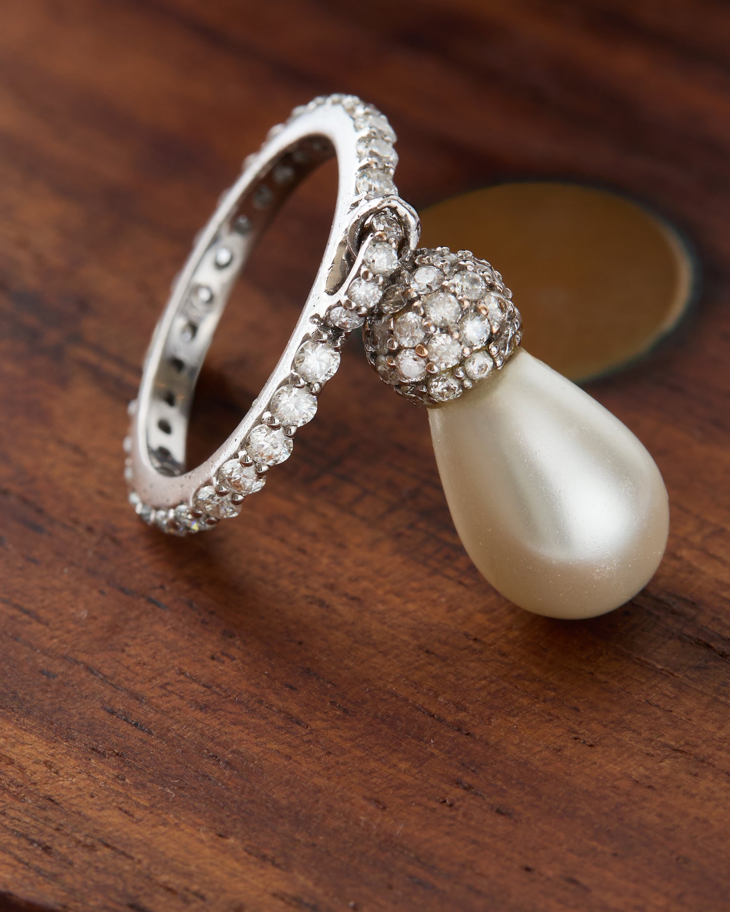 Detailed shot of the pearl's teardrop shape and the ring's gold band.