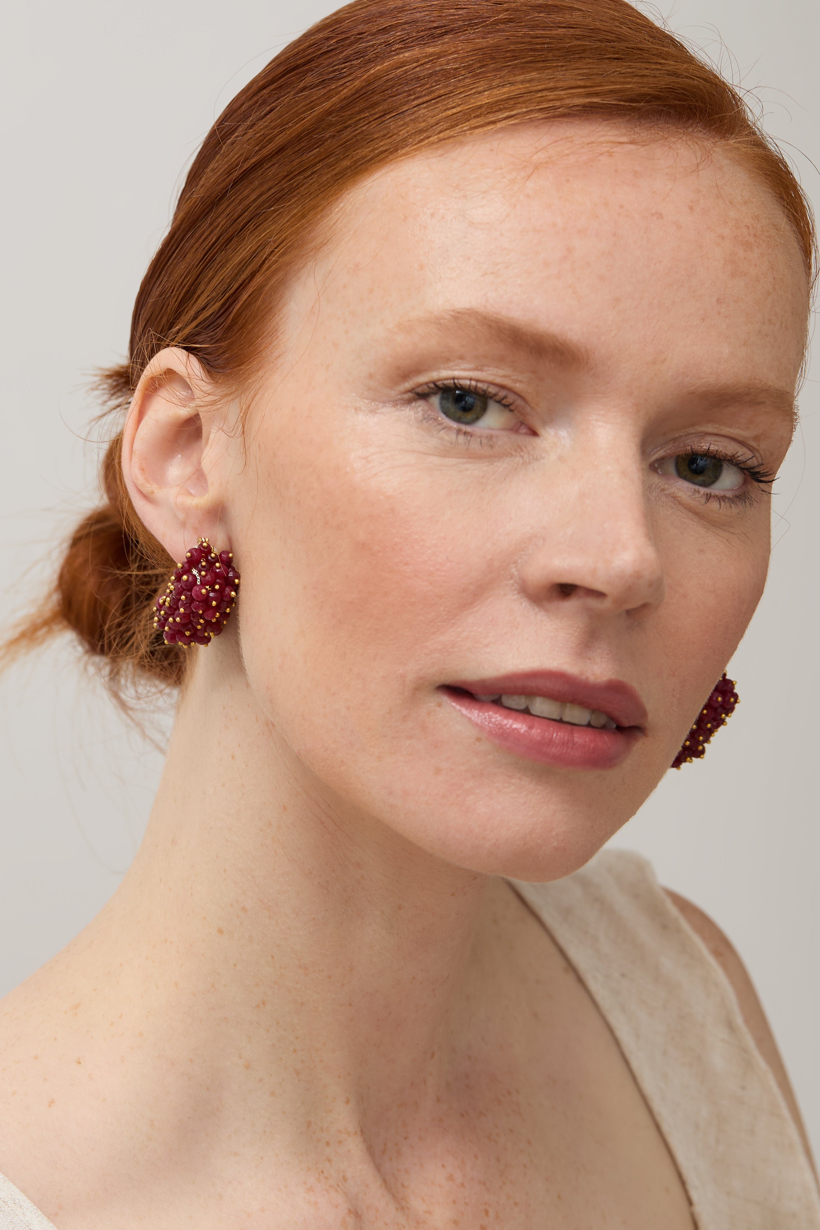Model wearing the ruby & pearl drop earrings.