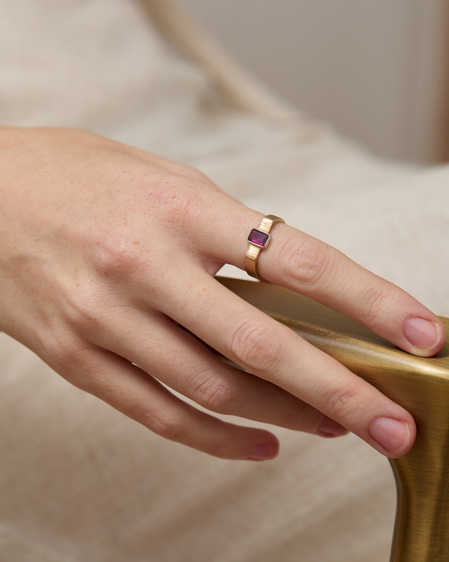 Model's hand adorned with the rhodolite cuff ring, showcasing its bold design.