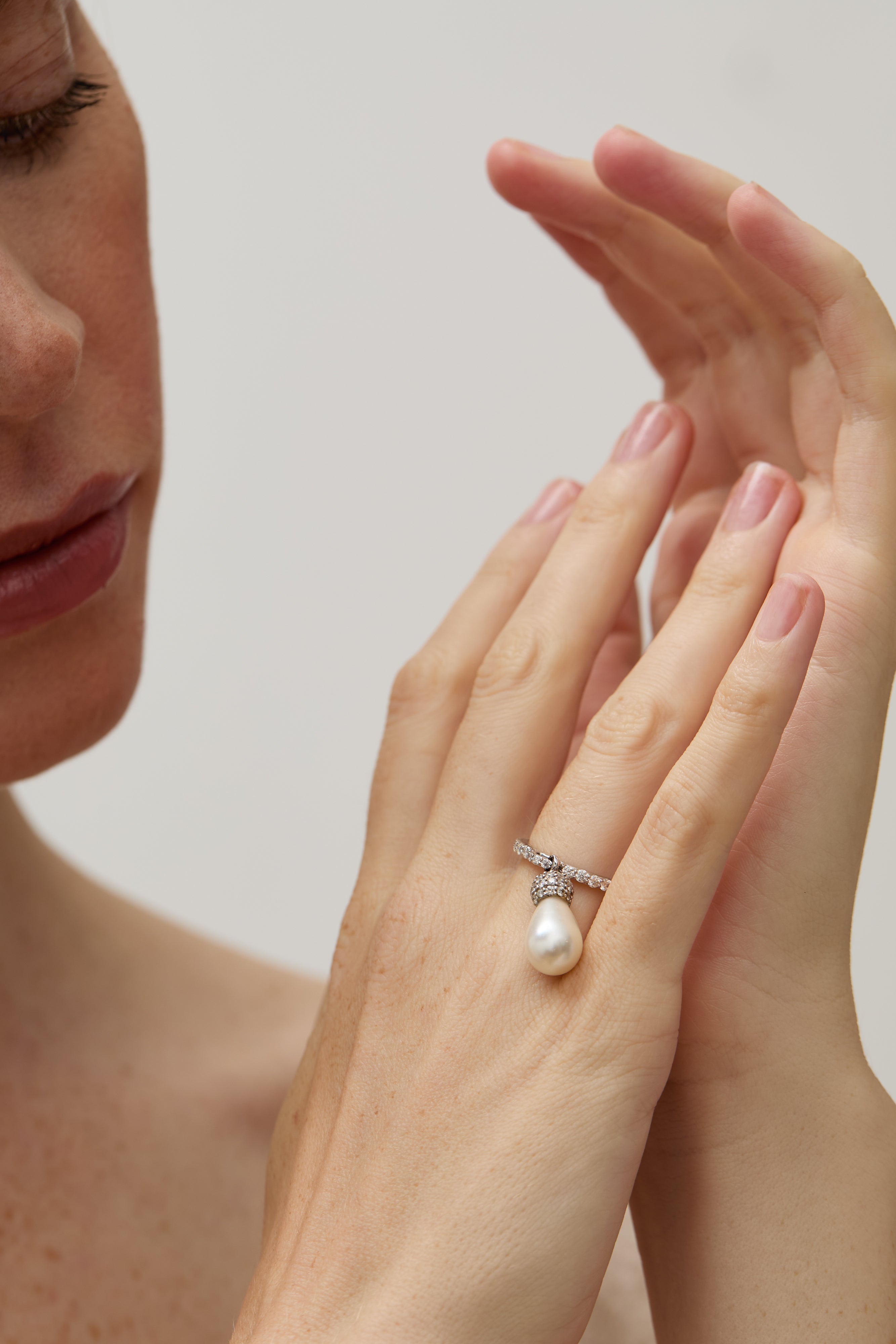 Model wearing the teardrop pearl ring, highlighting its delicate design.