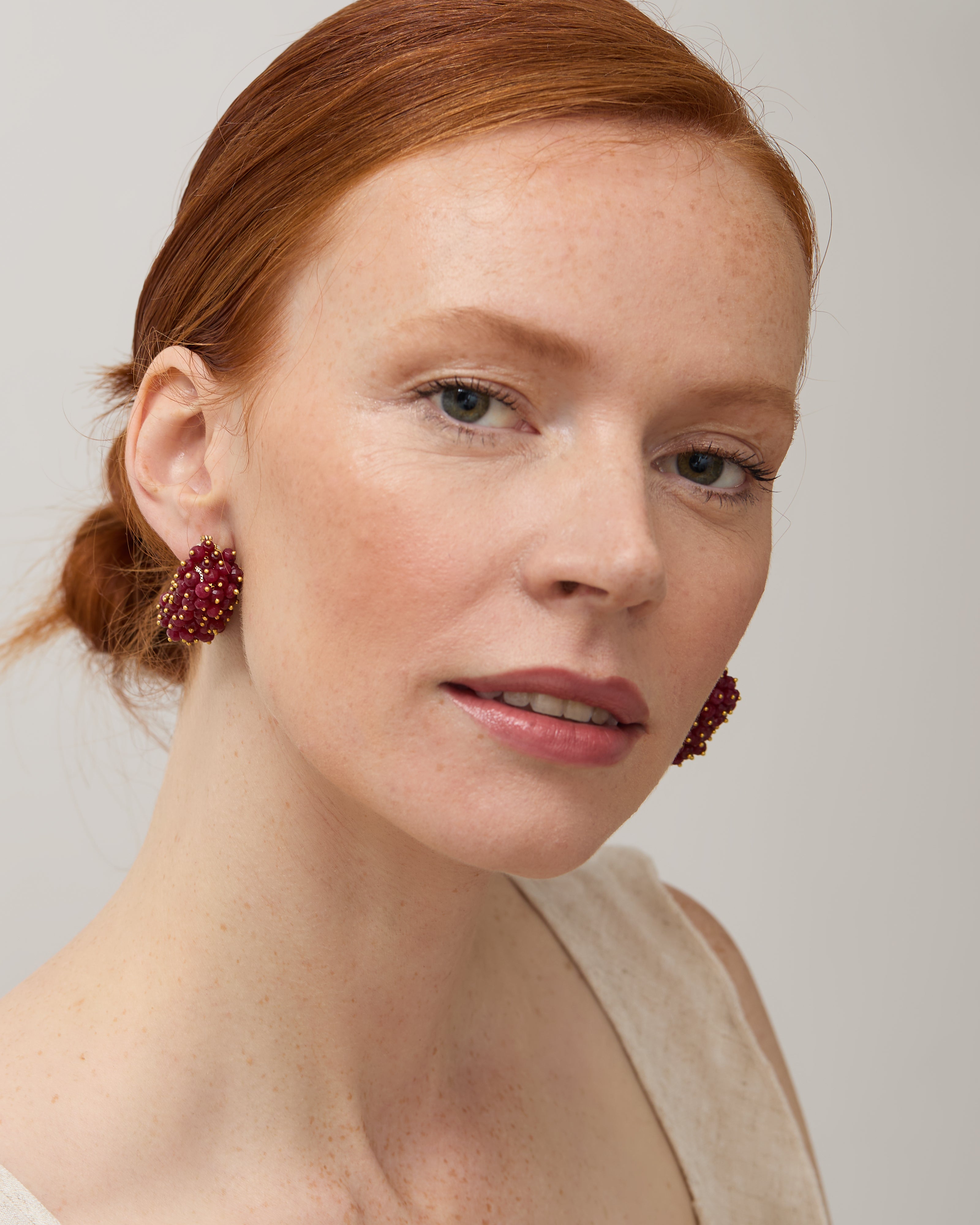 Model wearing the ruby & pearl drop earrings.