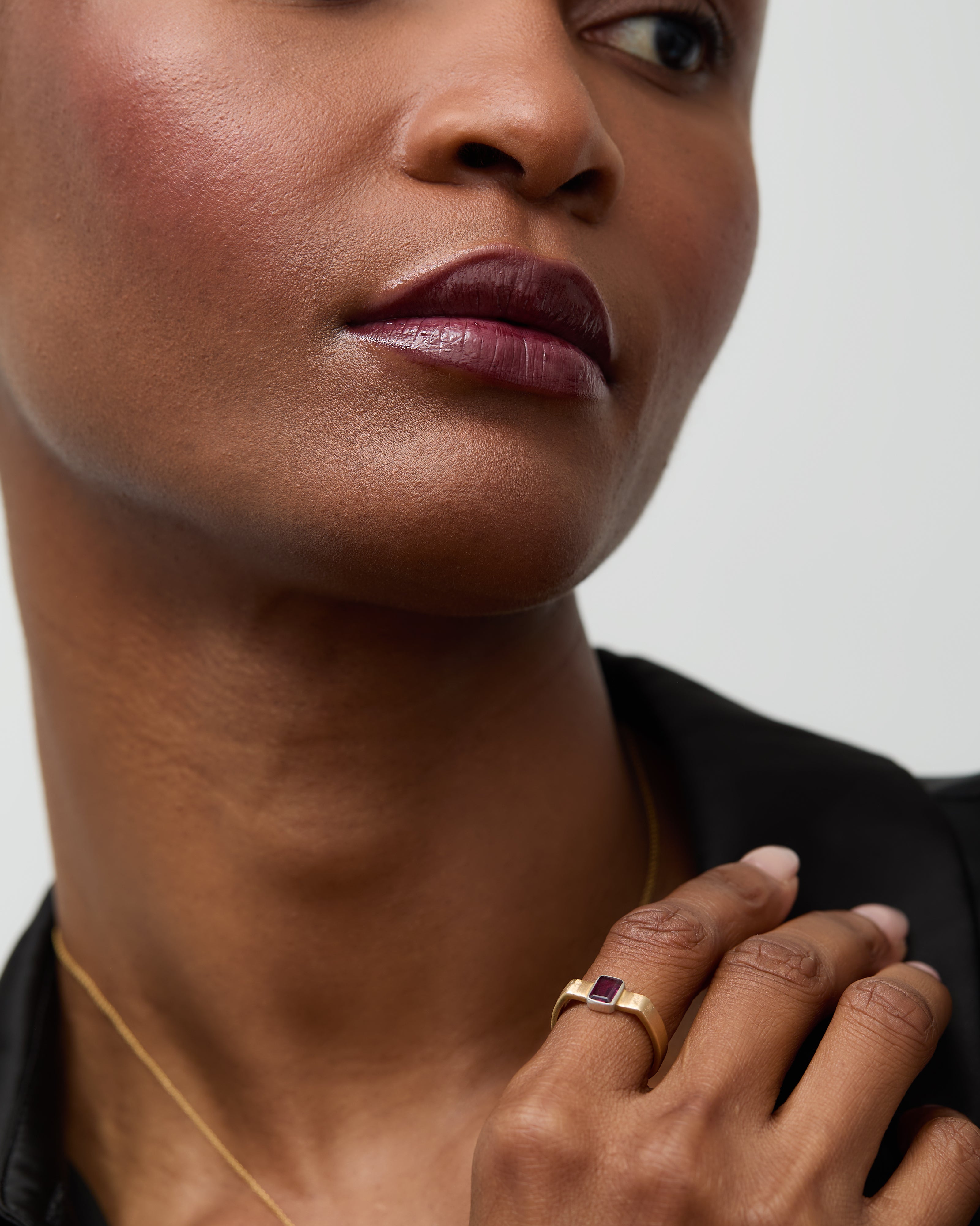 Model's hand adorned with the rhodolite cuff ring, showcasing its bold design.