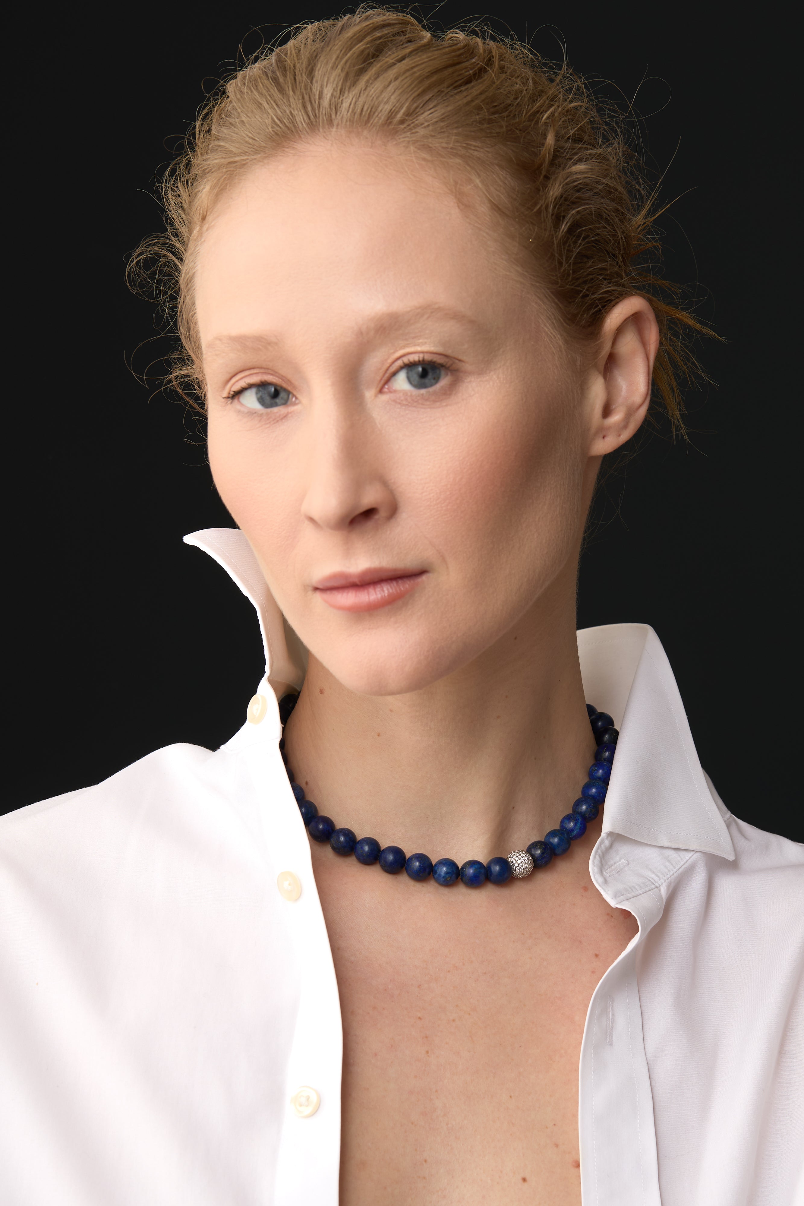 model wearing lapis lazuli necklace with crisp white shirt