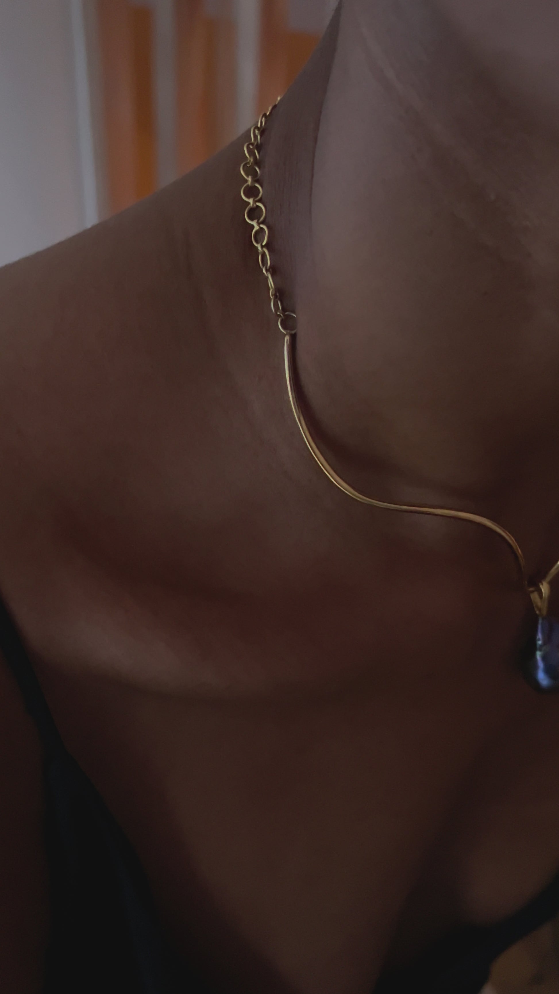 Video of model wearng the pear pendant on structured necklace